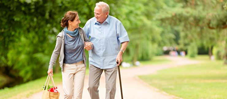 Daughter Walking with Her Elderly Father