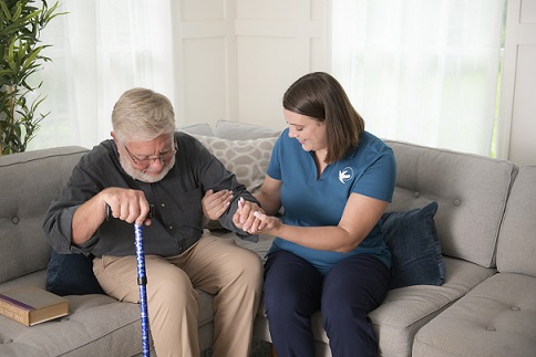 provider of home care in Damascus assisting elderly patient on to couch