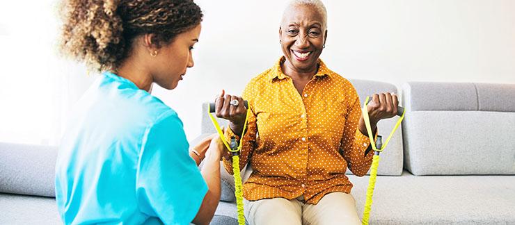 Home Care Worker Helping Senior With Physical Therapy