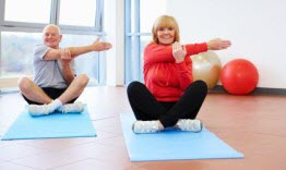 Seniors excercising by performing yoga