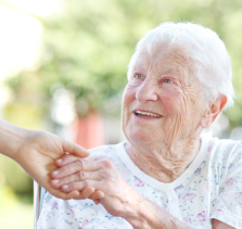 provider of at home care in Gresham shaking hands with elderly woman